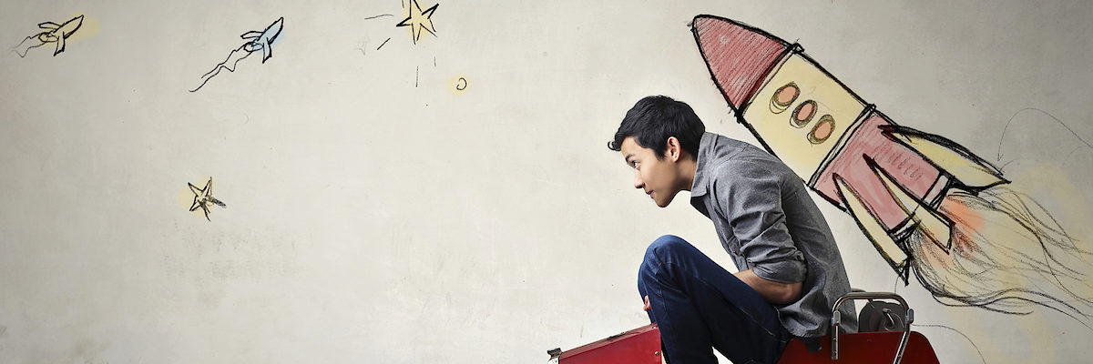 The portrait of a young Asian guy in a red toy car in front of a gray wall with spaceship and planets. Schlagwort(e): Spaceship, Travel, People Traveling, Boys, Men, East Asian Culture, Illustration, Play, Inspiration, Help - Single Word, Driveway, Color Image, Young Adult, Teenager, Playing, Playful, Flying, Leaving, Clambering, Driving, Drawing - Activity, Learning, Backgrounds, Chinese Ethnicity, Asian Ethnicity, Asian and Indian Ethnicities, Caucasian Ethnicity, Business Travel, Motivation, Support, Assistance, Imagination, Beginnings, Dreamlike, Growth, Speed, Concepts, White, Colors, Chinese Culture, Ideas, Business, Outdoors, Surface Level, Occupation, China - East Asia, Star - Space, Moon, Space, Sky, Fire - Natural Phenomenon, Wall - Building Feature, Street, Design, Leisure Games, Rocket, Car, Endorsing, Planetary Moon