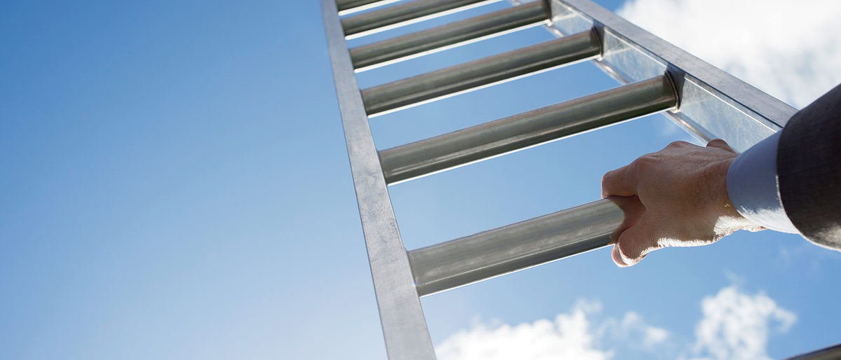 Businessman climbing the corporate ladder of success Schlagwort(e): corporate ladder, rung