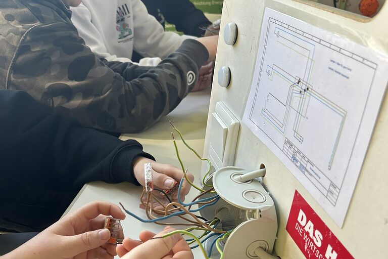 Eine Gruppe Schüler arbeitet an elektrischen Abzweigdosen.